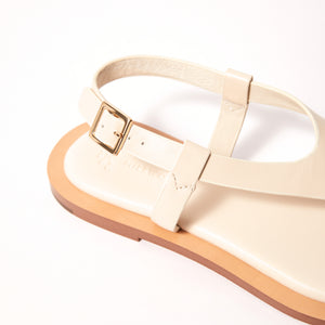 Single 3/4 view close up of Juniper Sandal in Crema, showcasing its intricate details and refined taste, designed to elevate your style with enduring quality.