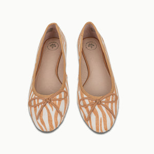 A front view of two crossed Banksia Ballet Flats in Brown Zebra pattern, showcasing their all-leather Calf Hair upper, added support around the heel, underfoot cushioning, and signature gum insert in the sole unit for comfort.