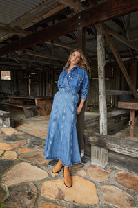 Model wearing a denim dress, showcasing Tan Suede Chelsea Boots, highlighting their versatility and timeless style