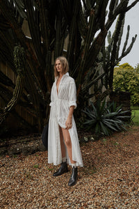 Model wearing a white dress, showcasing Oak Boots in Black, highlighting their versatility and timeless style.
