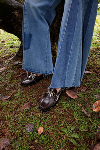 Close up on shoes: Model in denim, showcasing Penny Loafer in Brown , highlighting the stylish and comfortable design of the shoes