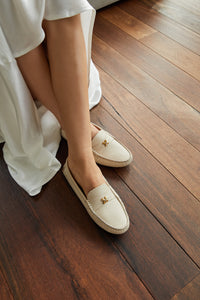 Close-up of a model's legs showcasing Kiowa shoes in Crema, highlighting the luxurious calf leather upper and the overall elegance of the product