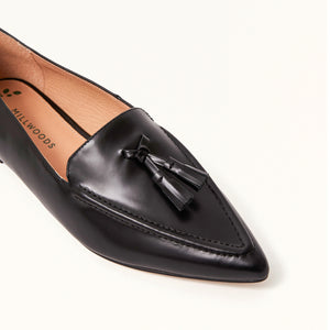 Close-up on toe view of The Poplar Pointed Flat in Black Leather with Tassels, showcasing the intricate detailing and craftsmanship, along with the stylish tassels