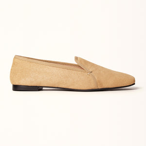 A champagne-colored ballet flat with a square toe design crafted from pony hair material, displayed in a side view.