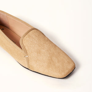 A single champagne-colored ballet flat with a square toe design, crafted from pony hair material, shown in a 3/4 view