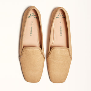A pair of champagne-colored ballet flats with a square toe design made of pony hair material, shown in a double view.