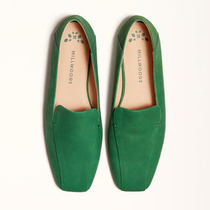 A pair of green square ballet flats displayed in a double front view for analysis