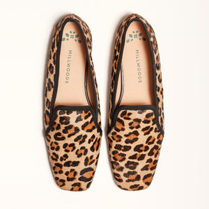 A pair of leopard-print square ballet flats displayed in a double front view, highlighting their design and pattern