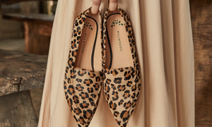 Millwoods Poplar Pointed Flat in Leopard being held by a woman