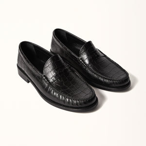 Double 3/4 view of Penny Loafer in Black Croc, showcasing the timeless design and embossed leather in a crocodile pattern for a stylish look