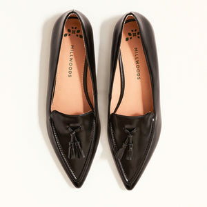 Double front view of The Poplar Pointed Flat in Black Leather with Tassels, emphasizing its sophisticated appearance and gum sole with a rubber insert for added traction