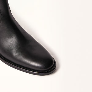 Close-up on toe view of Oak Boot in Black, showcasing the fine details of the leather construction and the classic design