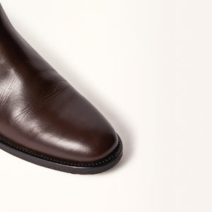 Close-up on toe view of Oak Boot in Brown, showcasing the fine details of the leather construction and the classic design