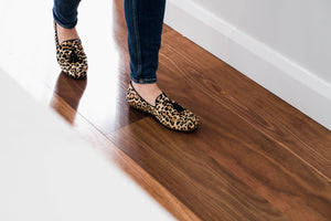 Close-up of a model walking wearing Linden Loafer shoes in Leopard print, emphasizing their stylish appearance and comfortable feel during movement.